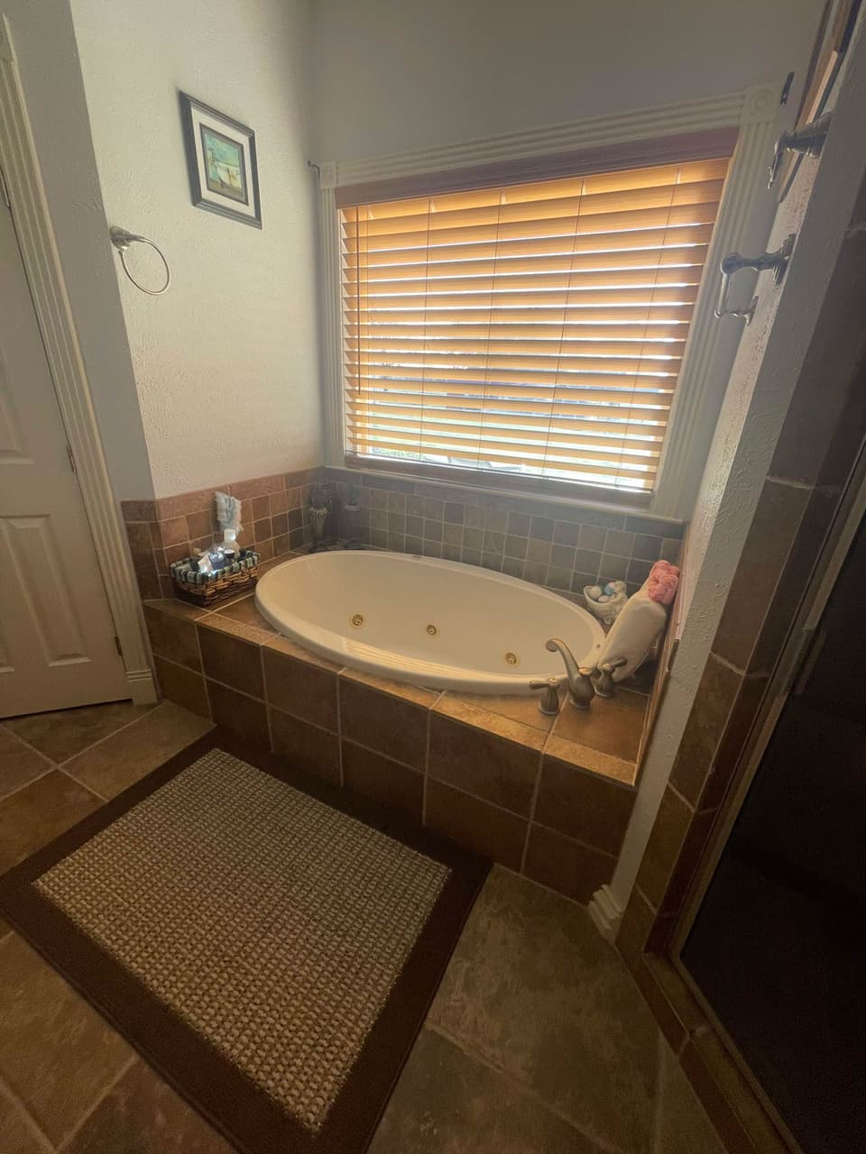 Ceramic tile surround around a jetted soaking tub in a Glen Rose, TX bathroom remodel